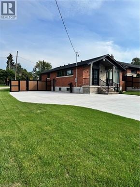 Stoney Creek apartment for rent - A house with a lawn in front of it.