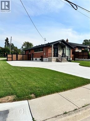 Stoney Creek apartment for rent - A house with a green lawn in front.