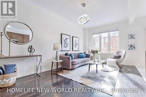Whitchurch-Stouffville (Stouffville) townhouse for rent - A well-lit living room with a grey sofa and a round mirror on the wall.