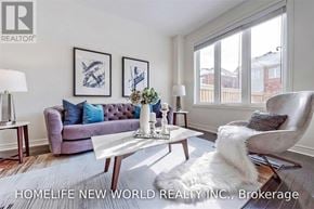 Whitchurch-Stouffville (Stouffville) townhouse for rent - A well-lit living room with a purple sofa and a white coffee table.