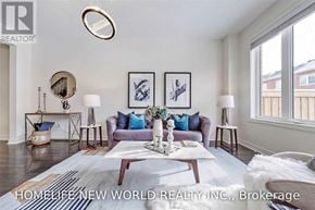 Whitchurch-Stouffville (Stouffville) townhouse for rent - A living room with a white couch and a coffee table in front of it.