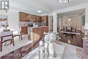 Whitchurch-Stouffville (Stouffville) townhouse for rent - A modern kitchen and dining area with a wooden floor and white walls.