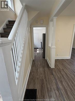 Windsor apartment for rent - A hallway with a staircase and a door at the end.