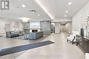 Hamilton (Durand) condo for rent - A spacious living room with a grey sofa and a television.