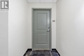 Hamilton (Durand) condo for rent - A grey door with a number 201 on the wall above it.