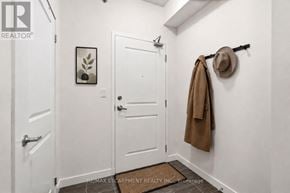 Hamilton (Durand) condo for rent - A hallway with a coat rack and a hat hanging on the wall.