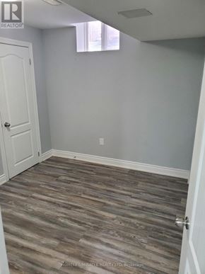Brampton (Bram East) apartment for rent - A room with a wooden floor and a white door.