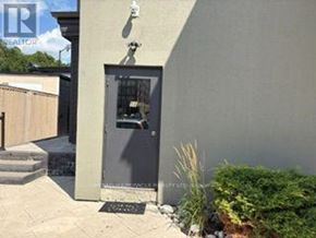Caledon (Bolton North) apartment for rent - A grey door with a glass window is flanked by a small step and a plant.