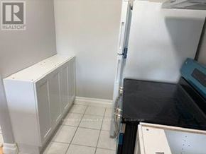 Caledon (Bolton North) apartment for rent - A white fridge in a kitchen with a white cabinet.