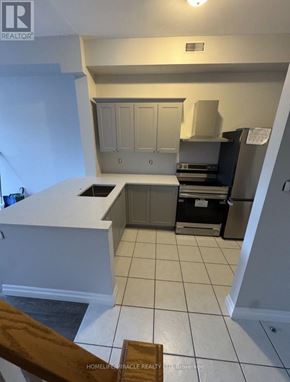 Caledon (Bolton North) apartment for rent - A kitchen with white cabinets and a white counter top.