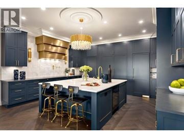 West Vancouver apartment for rent - A modern kitchen with dark blue cabinets and gold accents.