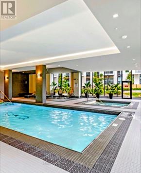 Oakville (Br Bronte) condo for rent - A swimming pool in a modern indoor setting.