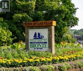 Oakville (Br Bronte) condo for rent - A sign that says "Town of Oakville Welcome to Bronte" is in front of some flowers.