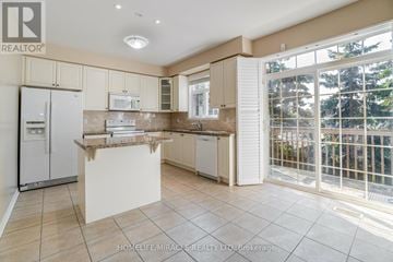 Pickering (Village East) townhouse for rent - A kitchen with a refrigerator, microwave, and oven.