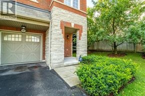 Pickering (Village East) townhouse for rent - A house with a garage door and a brick pillar.