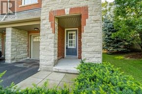 Pickering (Village East) townhouse for rent - A house with a stone facade and a blue door.