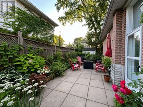 Newmarket (Central Newmarket) apartment for rent - A patio with a table and chairs surrounded by plants.
