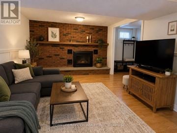 Newmarket (Central Newmarket) apartment for rent - A living room with a grey couch and a wooden coffee table.