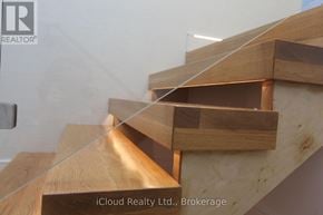 Tiny apartment for rent - A wooden staircase with glass balustrade.