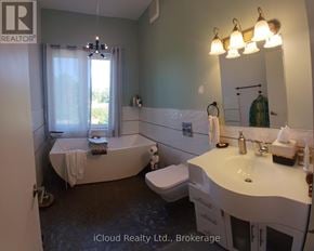 Tiny apartment for rent - A bathroom with a tub, toilet, and sink.