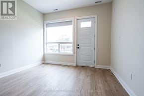 Hamilton (Hampton Heights) apartment for rent - A room with a white door and a window with a view of a building.