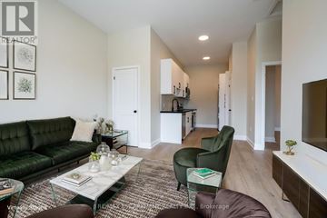 Hamilton (Hampton Heights) apartment for rent - A living room with a green couch and a glass coffee table.