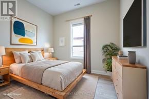Hamilton (Hampton Heights) apartment for rent - A bedroom with a bed, nightstand, and a painting on the wall.