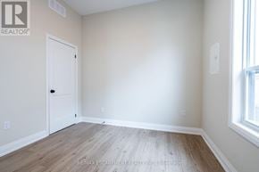 Hamilton (Hampton Heights) apartment for rent - A room with a white door and a window with a wooden floor.