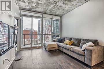 Toronto (Waterfront Communities) condo for rent - A living room with a grey couch and a large window.