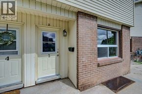 Cambridge townhouse for rent - A house with a realtor sign on the front door.
