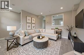 Cambridge townhouse for rent - A living room with a white couch, a coffee table, and a rug.