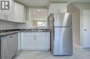 Cambridge townhouse for rent - A modern kitchen with a stainless steel refrigerator and white cabinets.