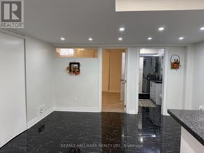 Vaughan (Maple) apartment for rent - A black marble floor in a white room with a wooden door.