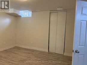 Vaughan (Maple) apartment for rent - A room with a white door and a window on the ceiling.