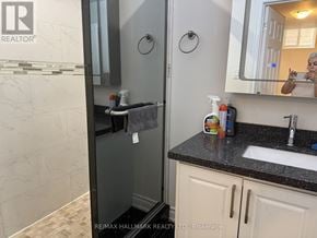 Vaughan (Maple) apartment for rent - A bathroom with a sink, mirror, and toiletries.