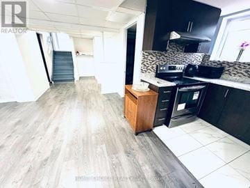 Brampton (Southgate) apartment for rent - A kitchen with a wooden cabinet and a black fridge.
