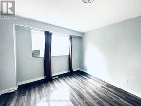 Brampton (Southgate) apartment for rent - A room with a window and a sign on the wall.