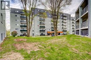 London apartment for rent - Apartment complex with a grassy area in front.