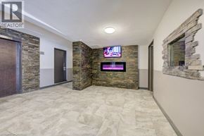 London apartment for rent - A living room with a stone wall and a flat screen TV mounted on it.