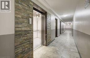 London apartment for rent - A hallway with a stone wall and a glass door.