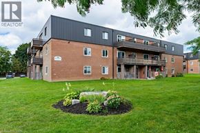 London apartment for rent - A large building with a lawn in front of it.