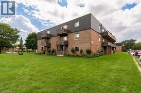 London apartment for rent - A large building with a lawn in front of it.