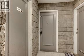 London apartment for rent - A hallway with a door and a sign on the wall.