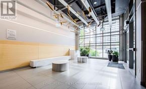 Toronto (Little Portugal) condo for rent - A reception area with a white bench and a sign that says "REALTOR".