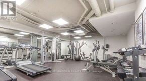 Toronto (Little Portugal) condo for rent - A well-equipped gym with various exercise machines and weights.