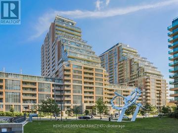 Toronto (Niagara) condo for rent - A large blue sculpture resembling a DNA double helix stands in front of a row of modern apartment buildings.