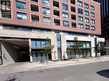 Toronto (Leaside) condo for rent - A building with the words "Upper East Village" on the front.