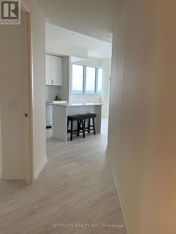 Vaughan (Vellore Village) house for rent - A hallway leading to a kitchen with white cabinets and a window.
