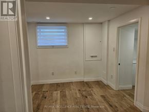 Kitchener apartment for rent - A room with wooden flooring and a window with blinds.