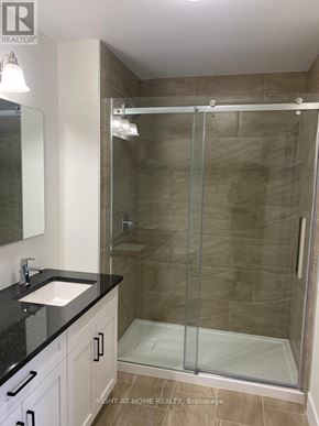 The Nation townhouse for rent - A bathroom with a walk-in shower and a sink.